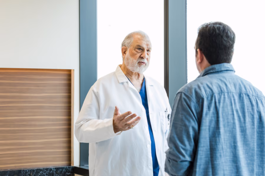 Urologist discussion penile implant surgery with male patient in medical setting