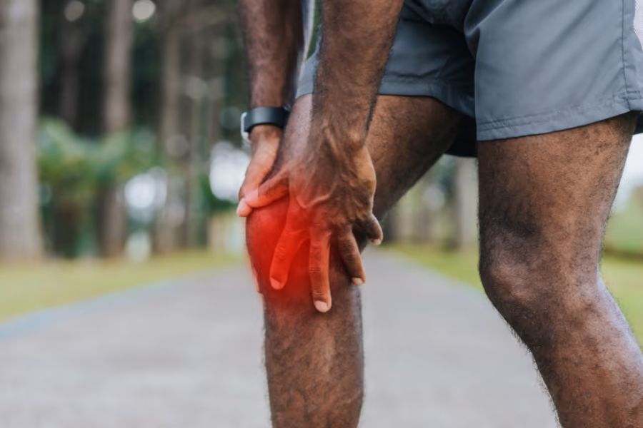 Visualized ACL tear, man holding his knee in pain on basketball court.