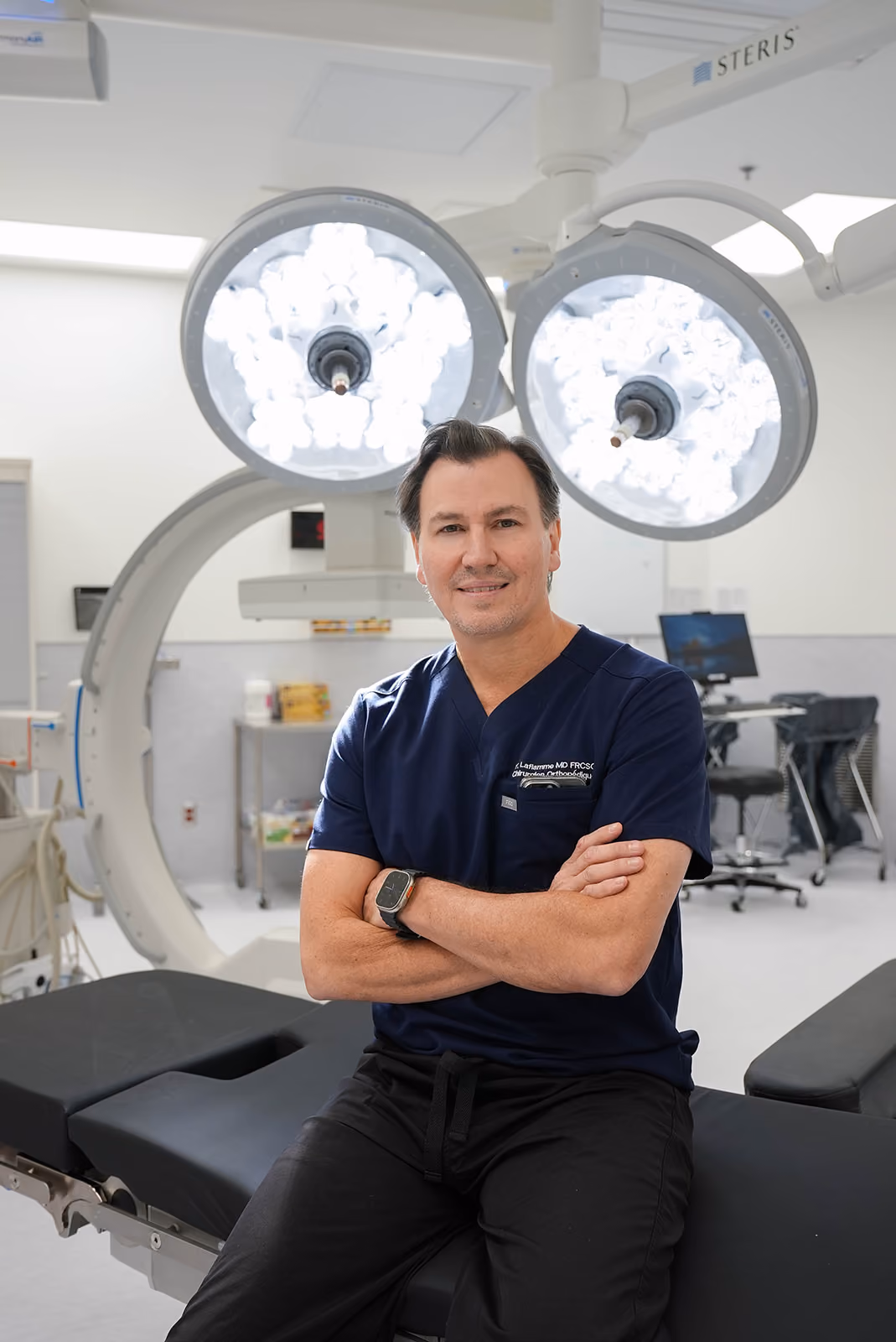 Dr. Yves Laflamme sitting on operating room table