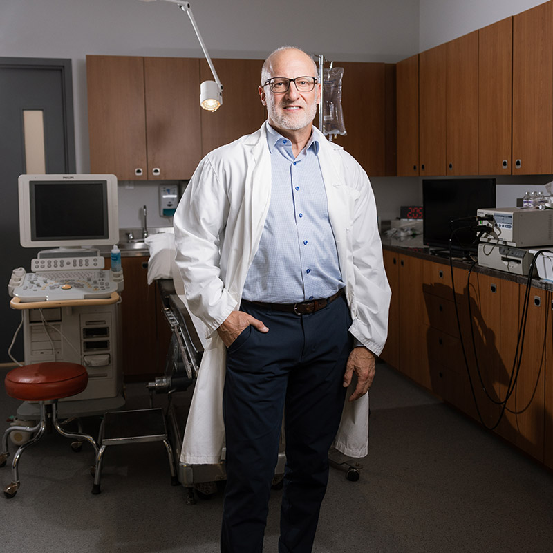 Dr. Eiley in clinical setting wearing a lab coat.