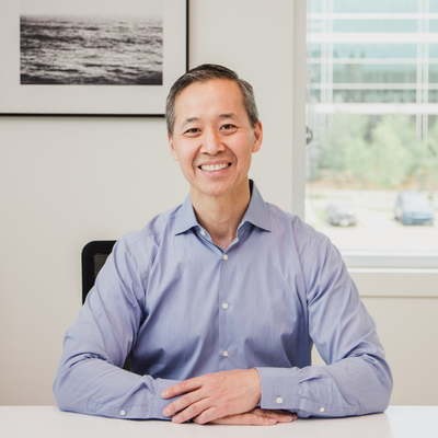 Dr. Lo sitting in sunny Gateway Surgery office