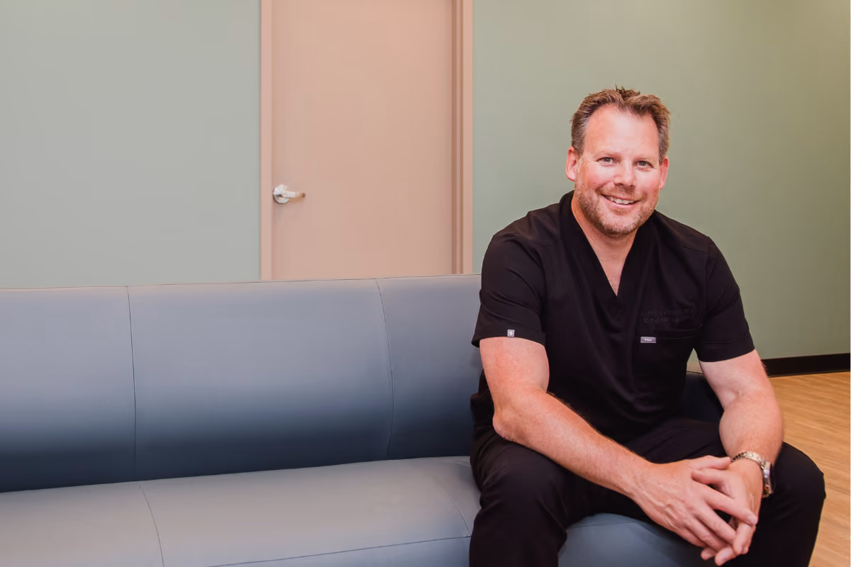 Dr. Justin Leblanc seated on a waiting room couch in Gateway surgery.
