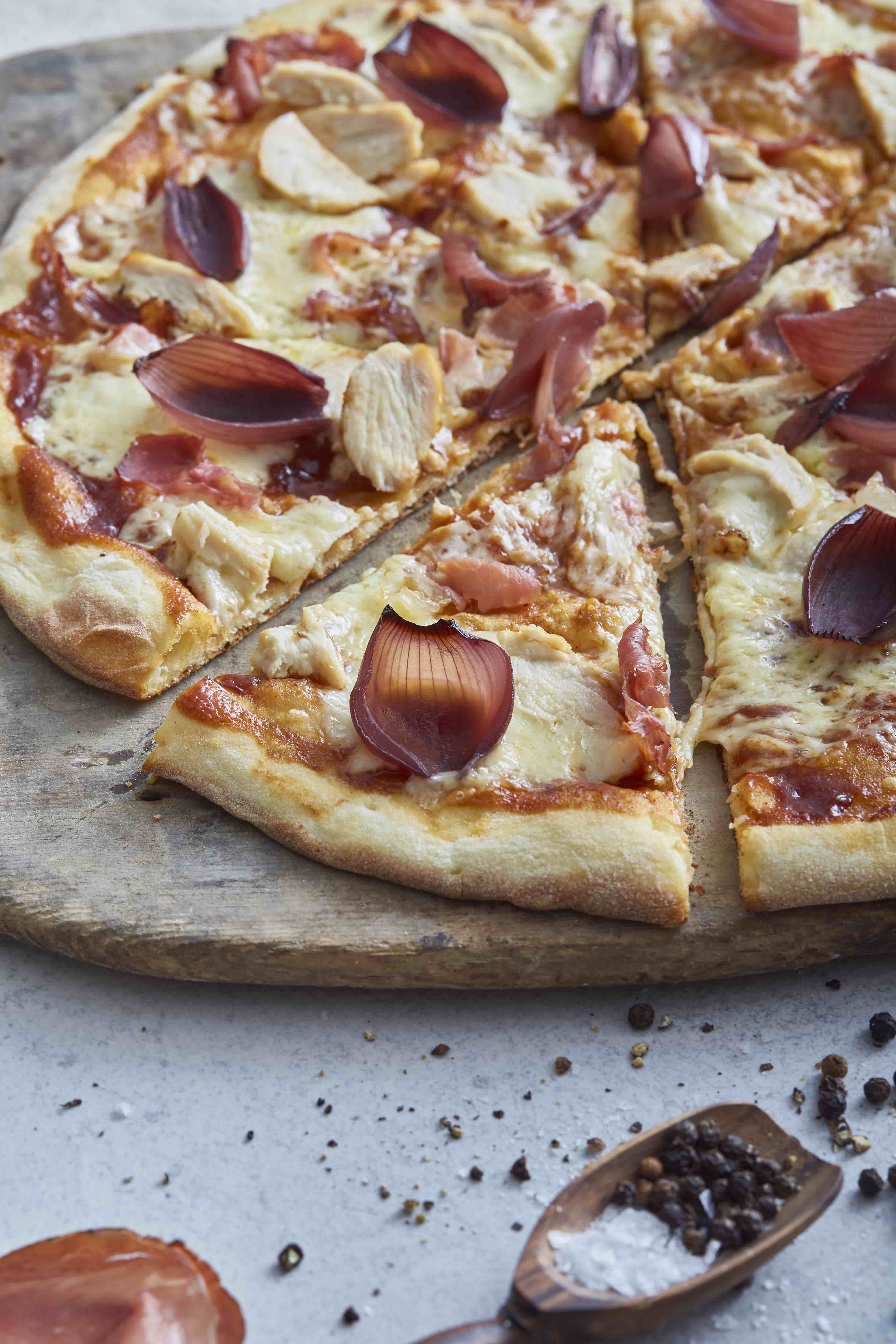 Thin pizza coming out from the oven