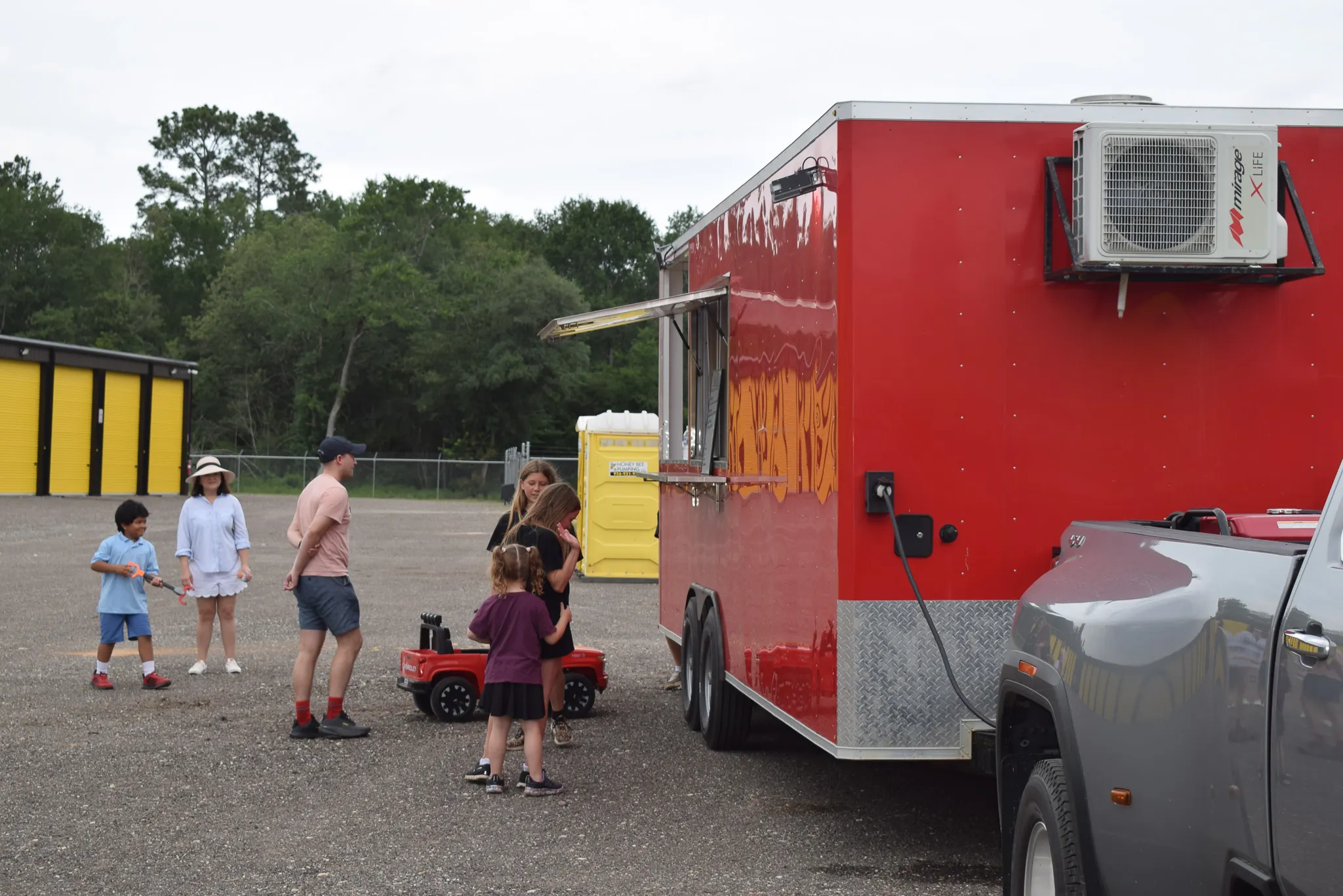 Guests gathered under a canopy beside the storage units during the Foxgate Boat & RV Storage grand opening event.