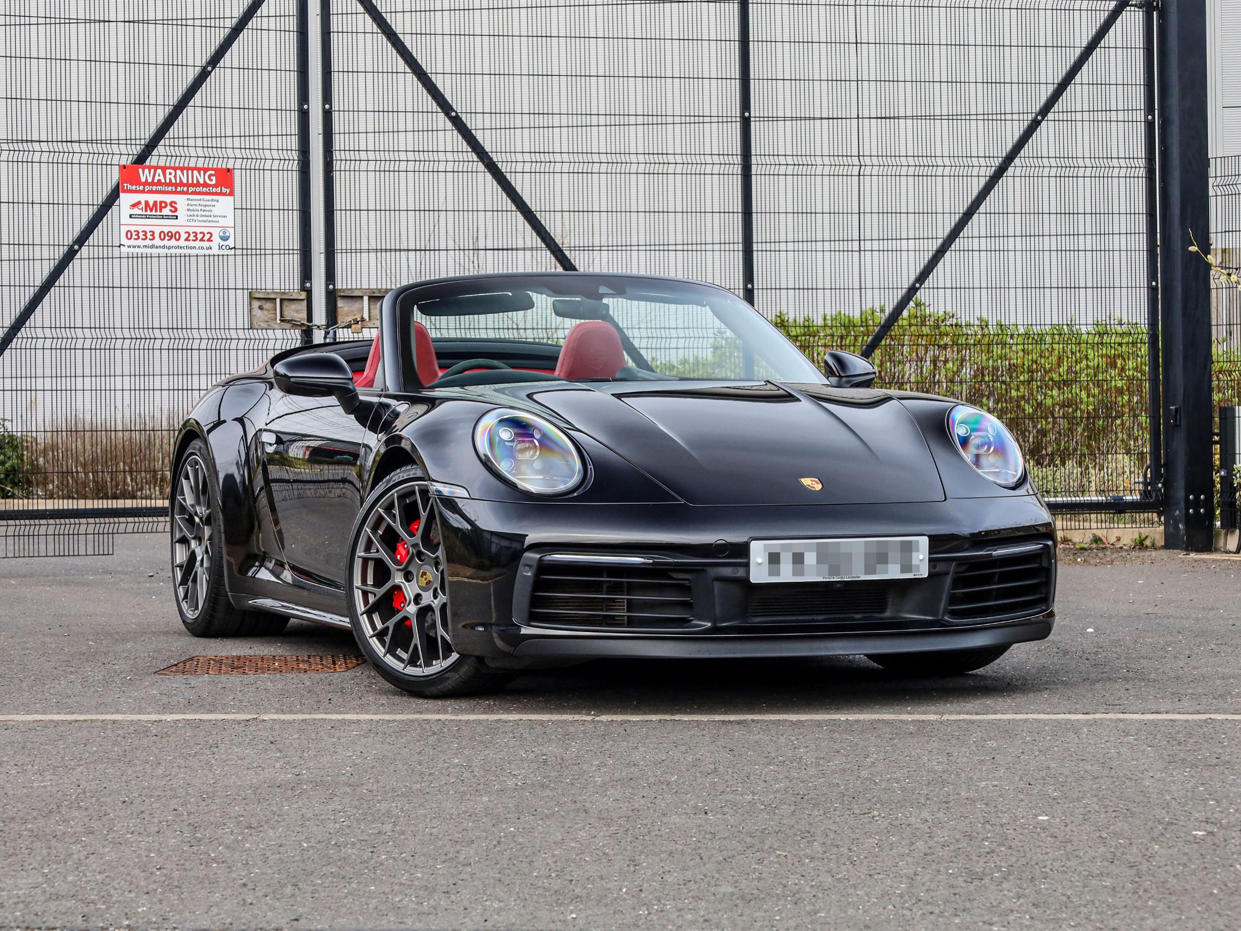 Black Porsche 911 with convertible roof down