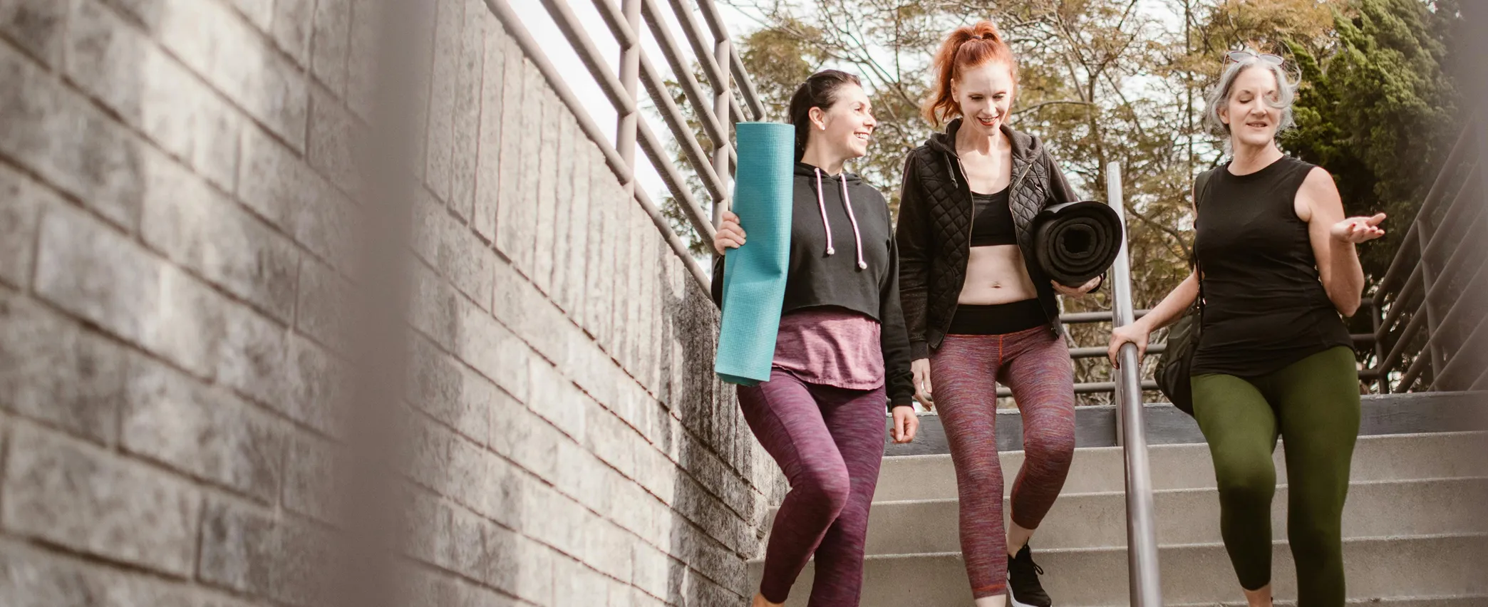 A group of women walking down a flight of stairs.