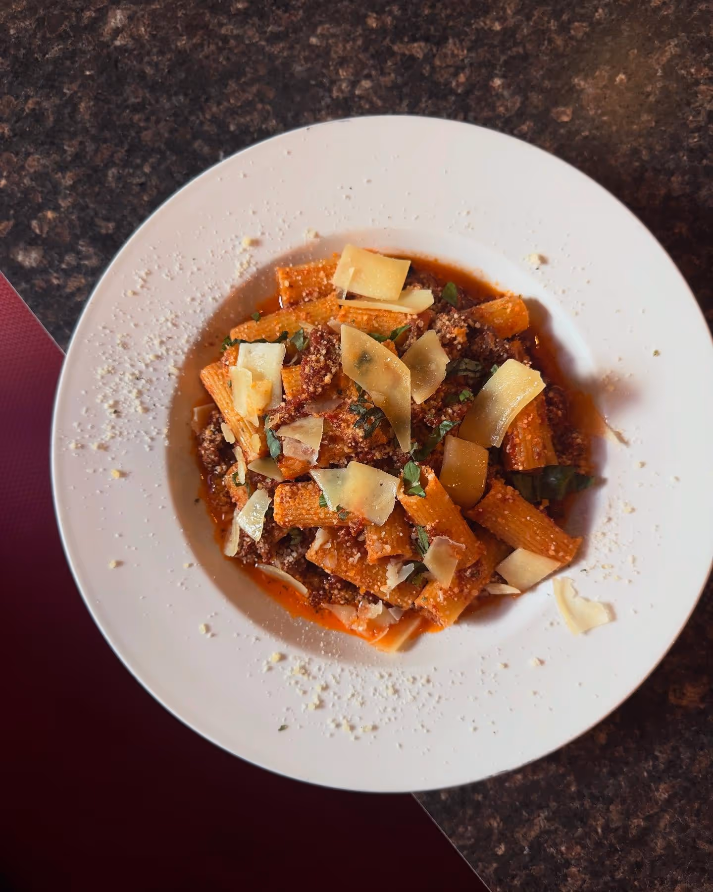 pasta bolognese with parmesan cheese on top