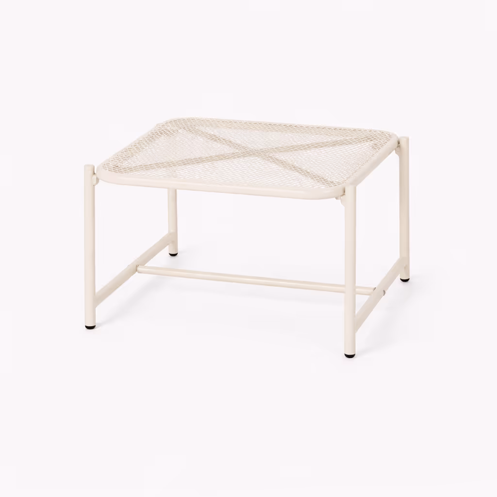 A white outdoor side table with mesh top against a white background