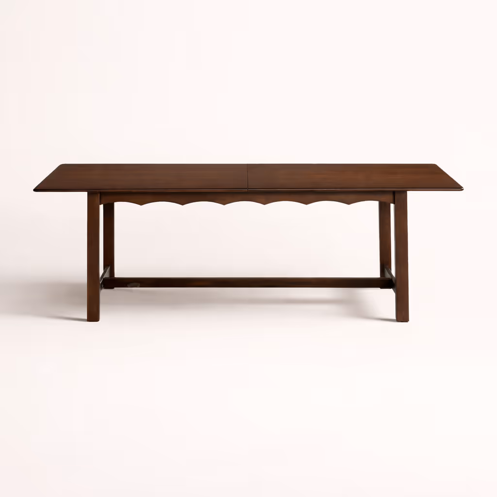 A rectangular walnut dining table against a white background.