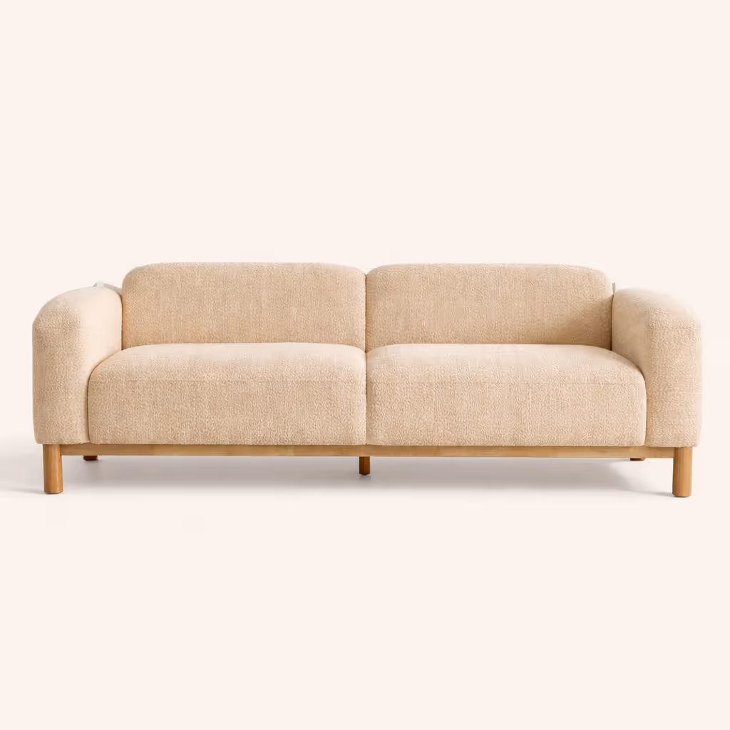 A cream-colored boucle sofa against a white background