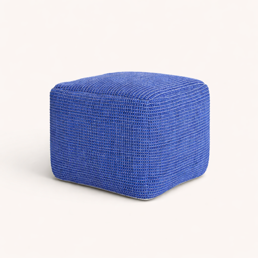 A cube-shaped blue pouf against a white background.