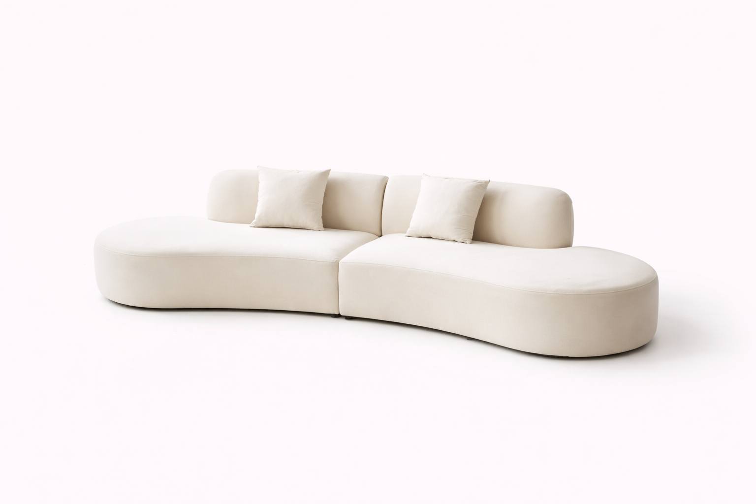 A white upholstered half-moon shaped sofa against a white background.