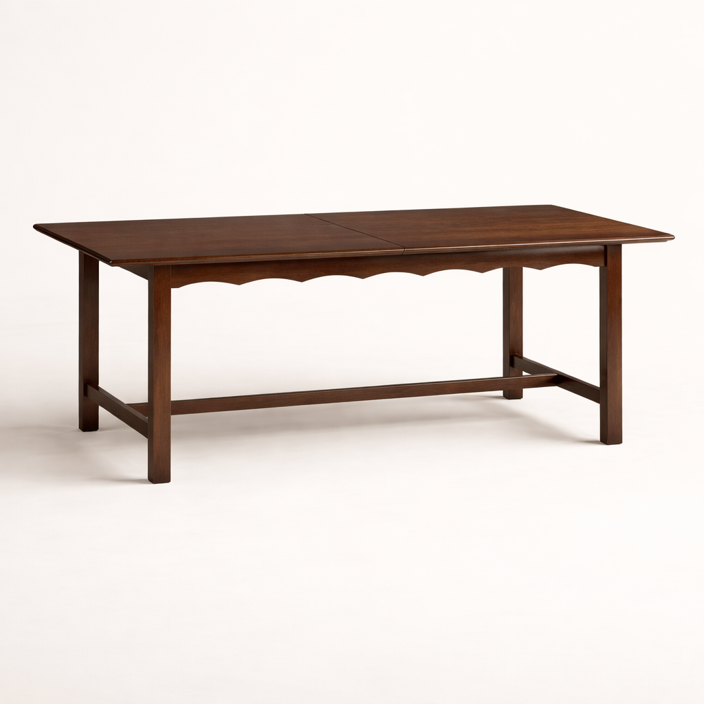 A walnut dining table with scalloped edges against a white background.