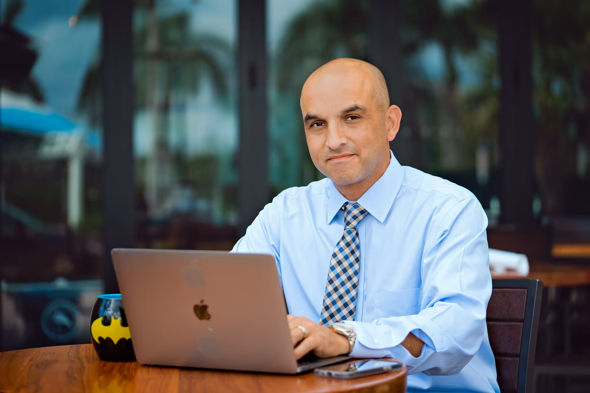 Kristopher Torres, Esq., Florida personal injury attorney, smiling while reviewing a message on his phone