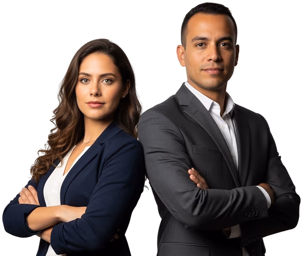 Confident professional man and woman standing side by side with arms crossed against a black background.