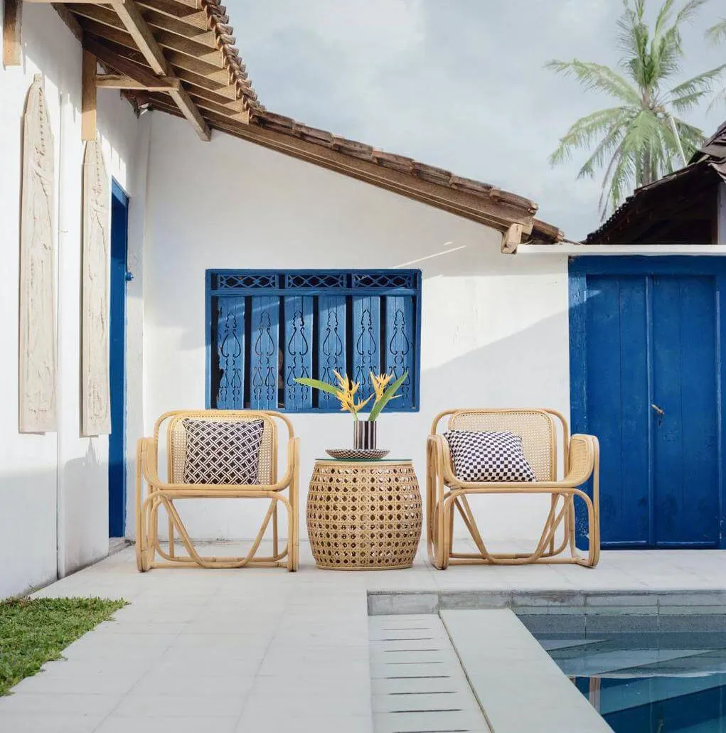 wicker table and two chairs near swimming pool