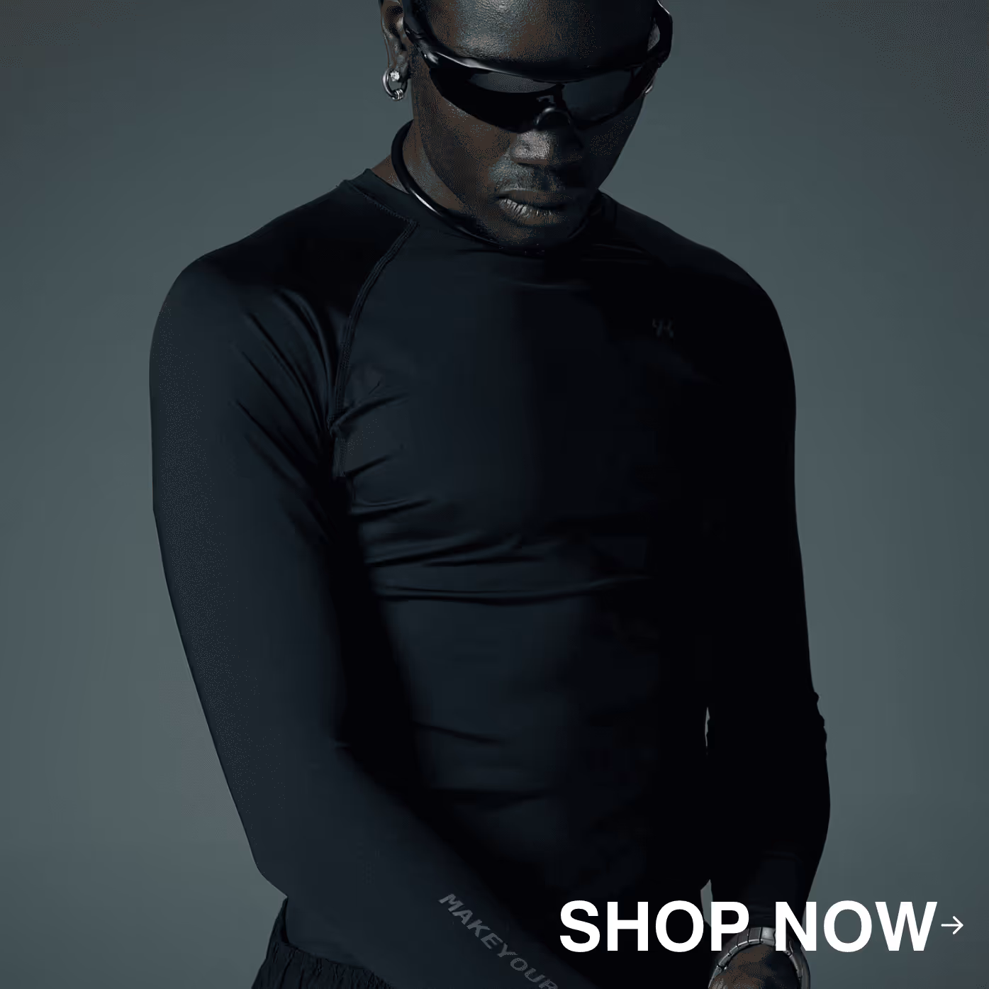 Man wearing black athletic wear and sunglasses, looking down with 'SHOP NOW' text overlay in bottom right.