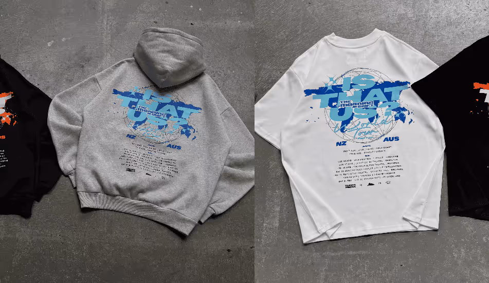 Gray hoodie and white long-sleeve shirt laid flat, both with blue text and graphic design on the back including the phrase 'IS THAT US'.