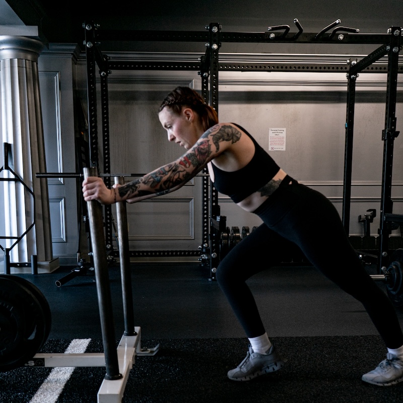 woman pushing weights on turf at X Shadyside