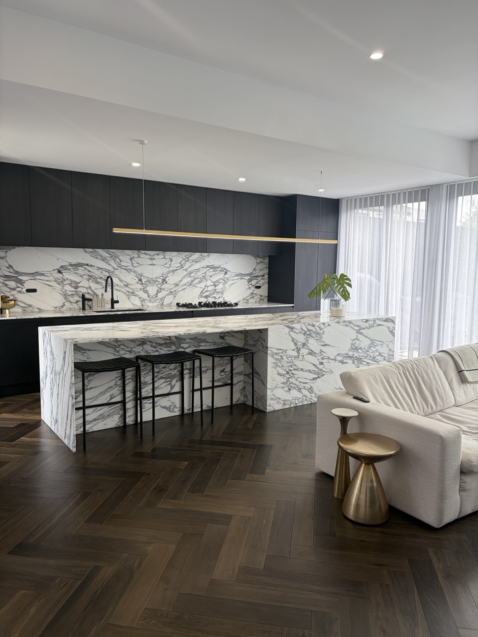 Clean kitchen with gleaming appliances.