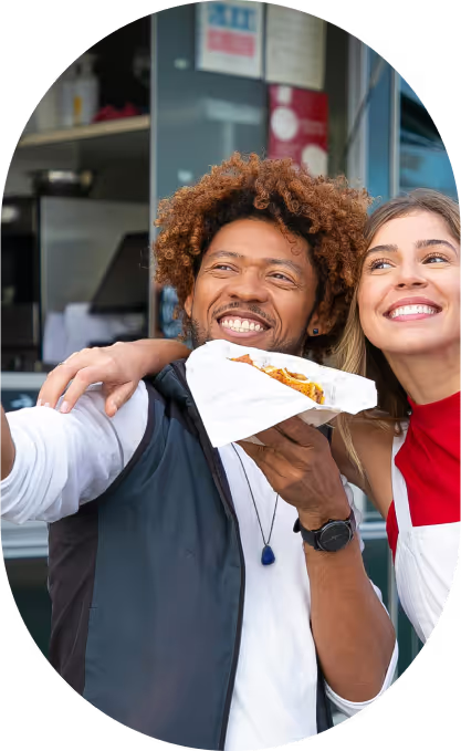 Free Happy multiethnic friends with burgers taking selfie near food truck Stock Photo