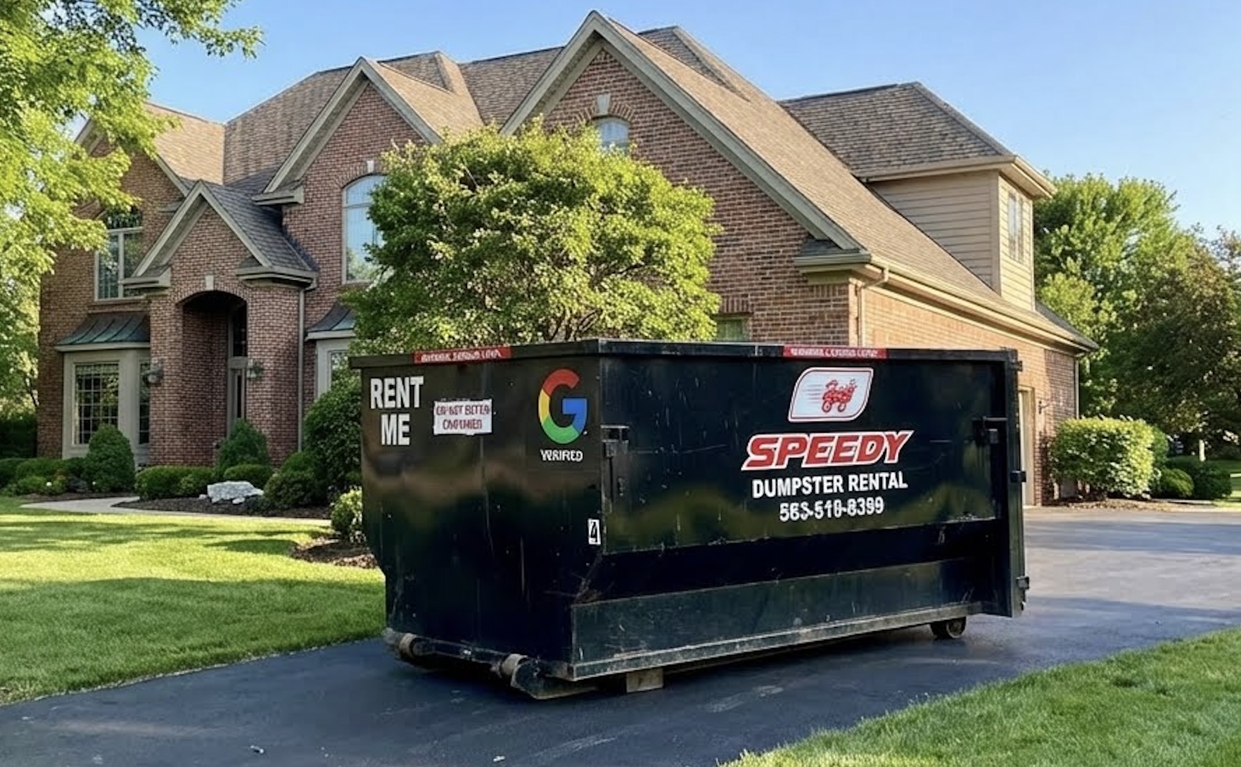 Large black dumpster with Speedy Dumpster Rental branding placed on a driveway in front of a brick house with green lawn and trees.