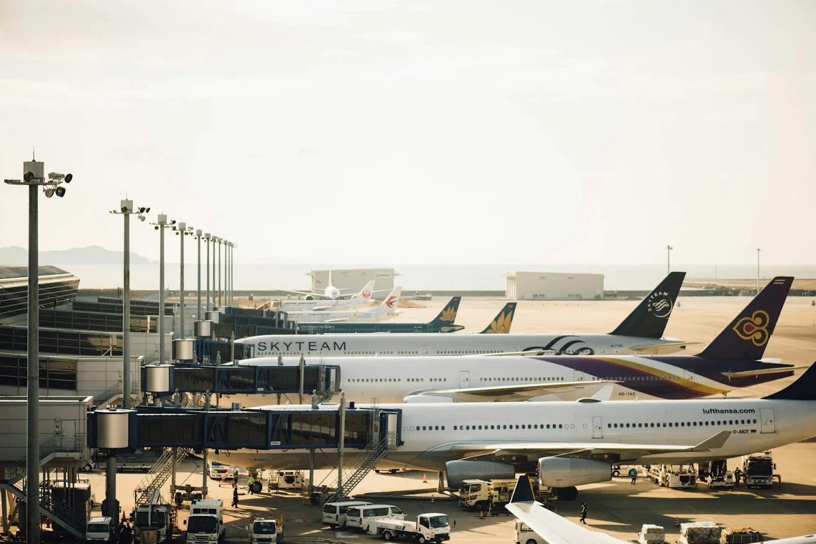 An airport line of Sky Team planes on at dusk