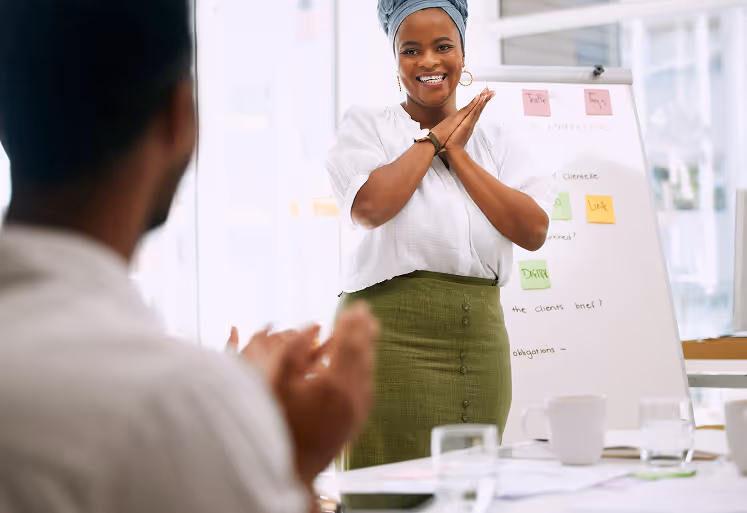 Wellness coach guiding an employee through light stretching during a corporate session.