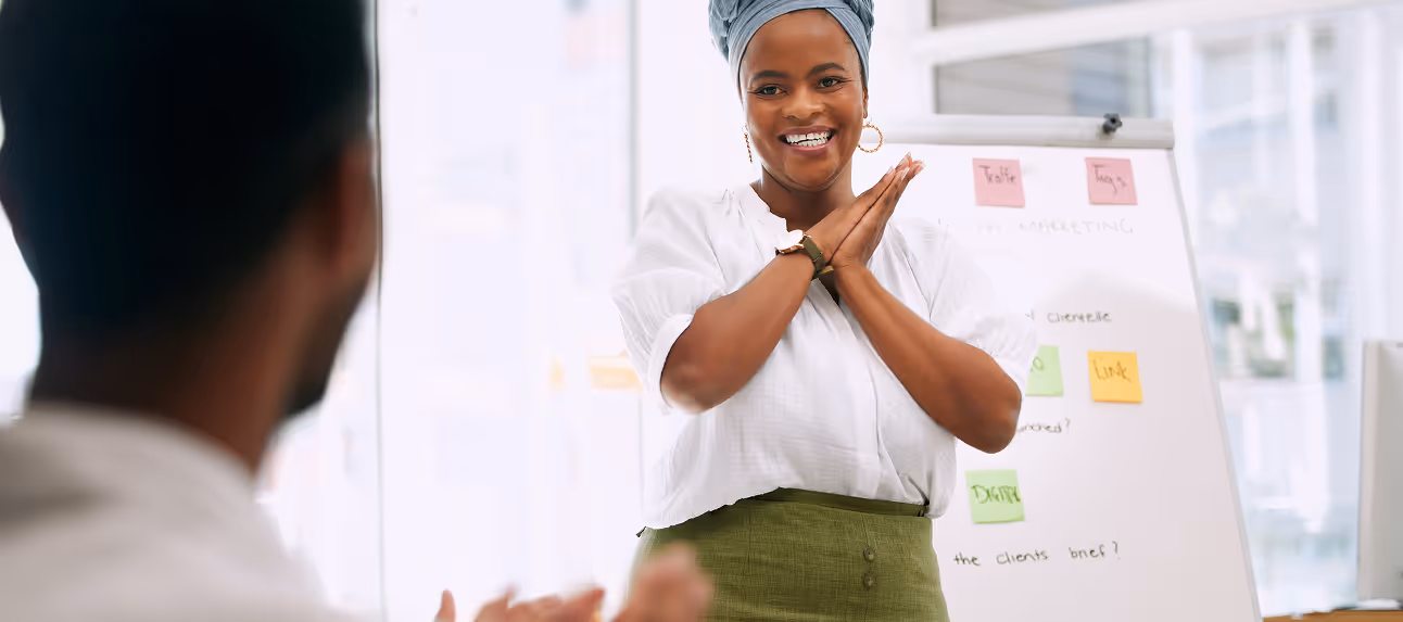 Wellness coach guiding an employee through light stretching during a corporate session.