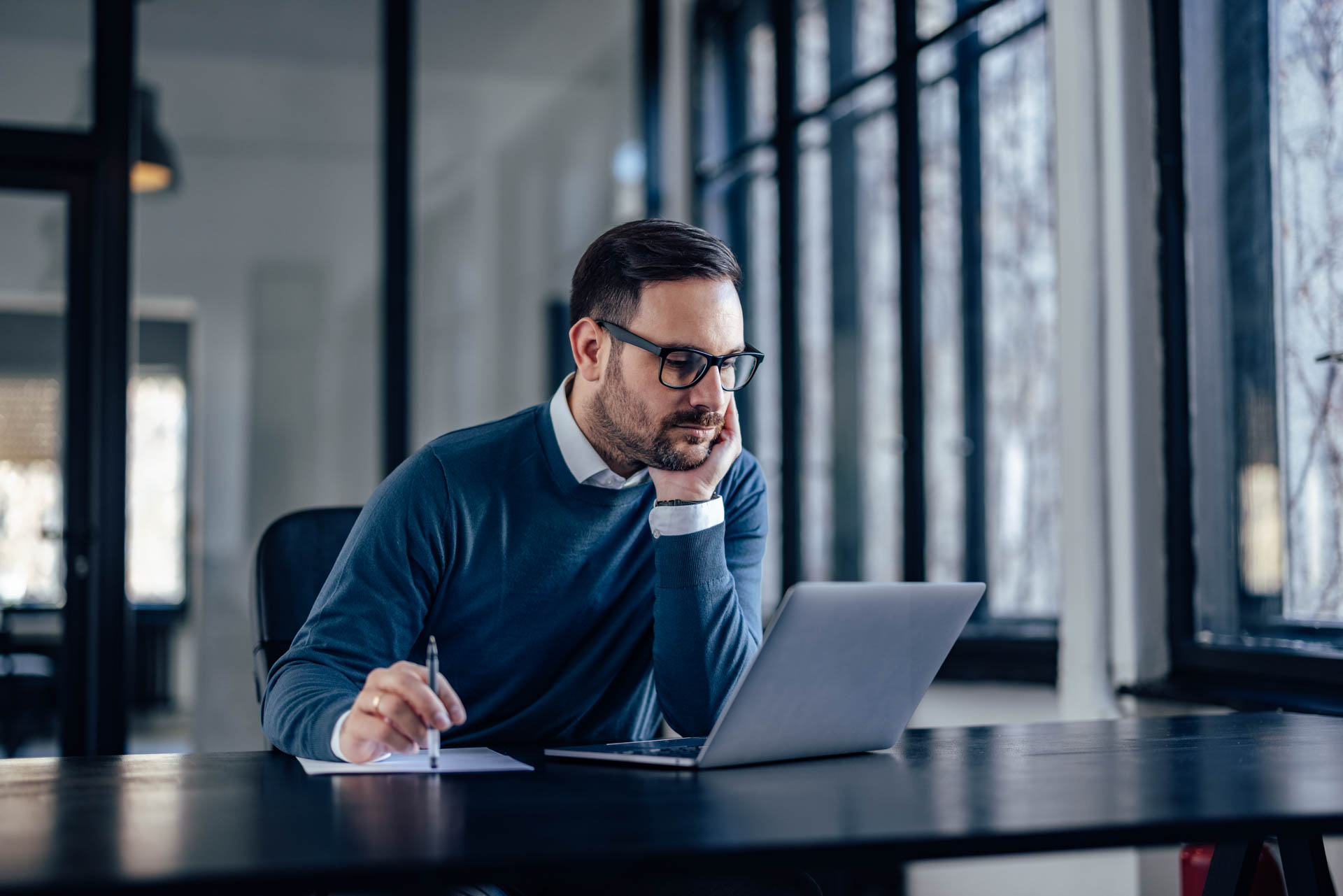 working man sitting in front of a laptop