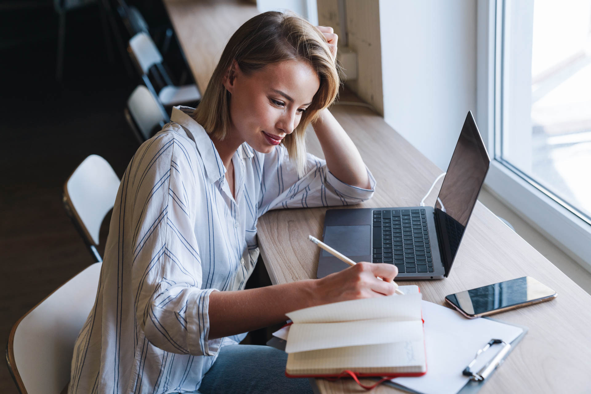 a women working on a laptop in a modern office