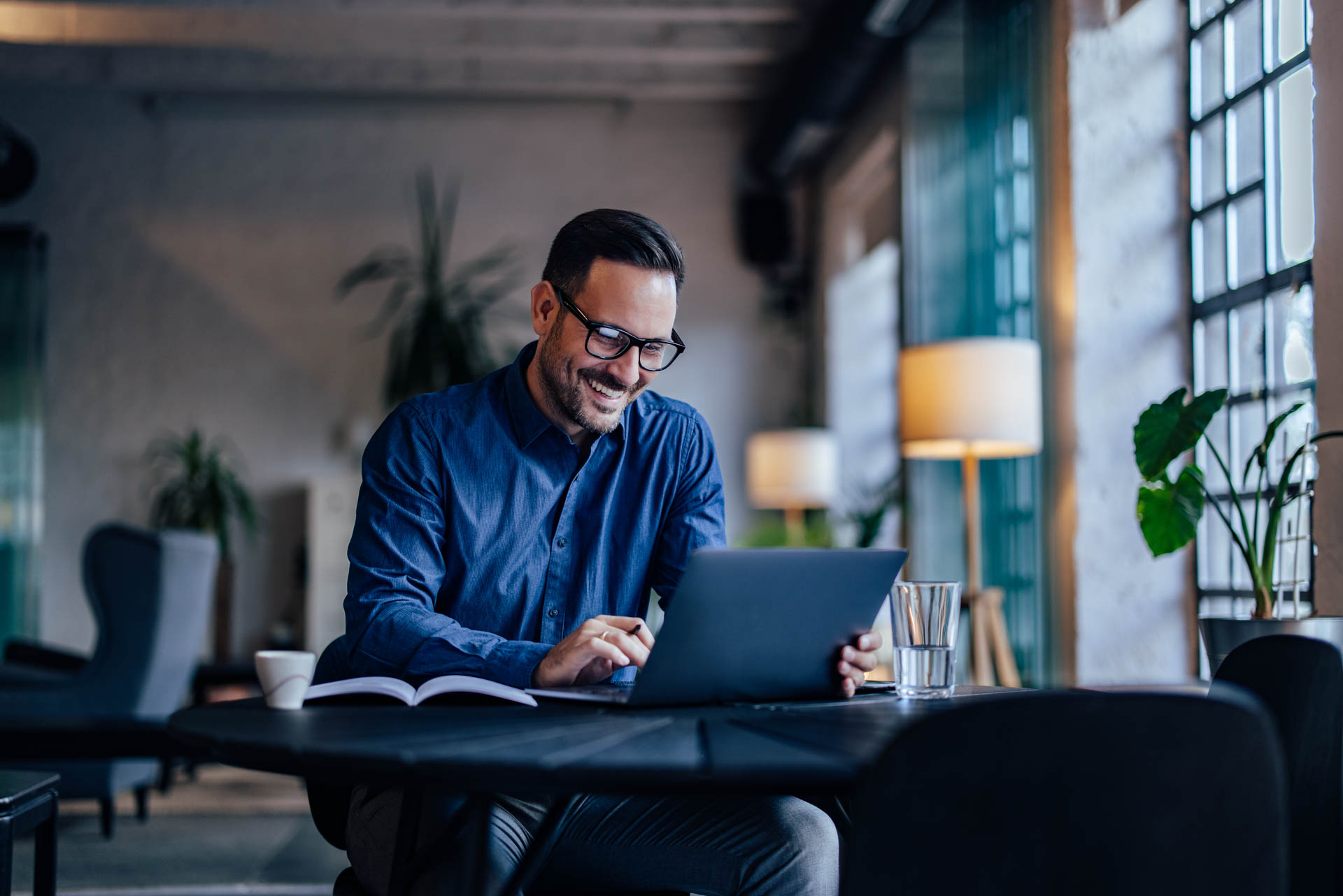 working man sitting in front of a laptop