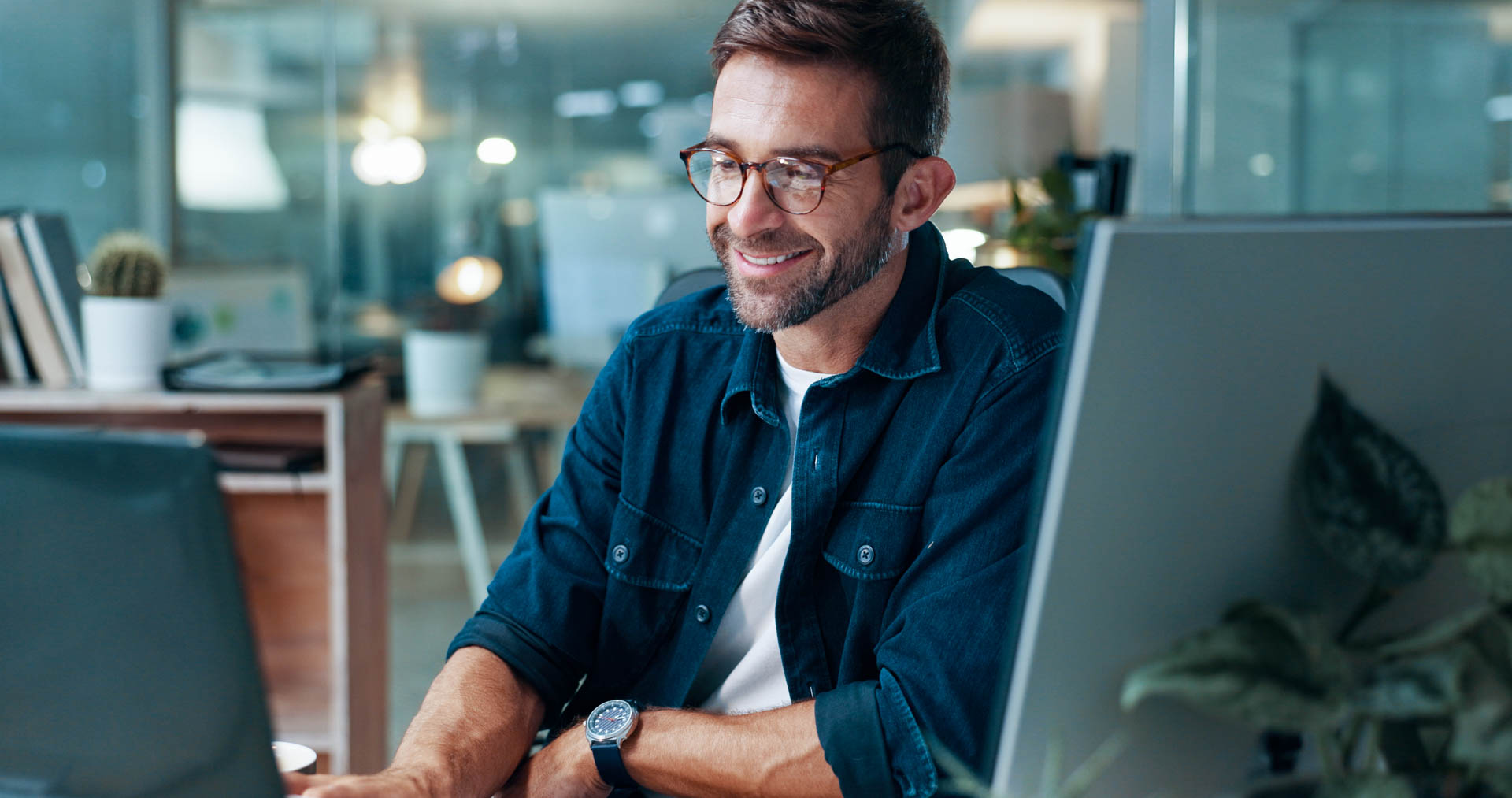 working man sitting in front of a laptop