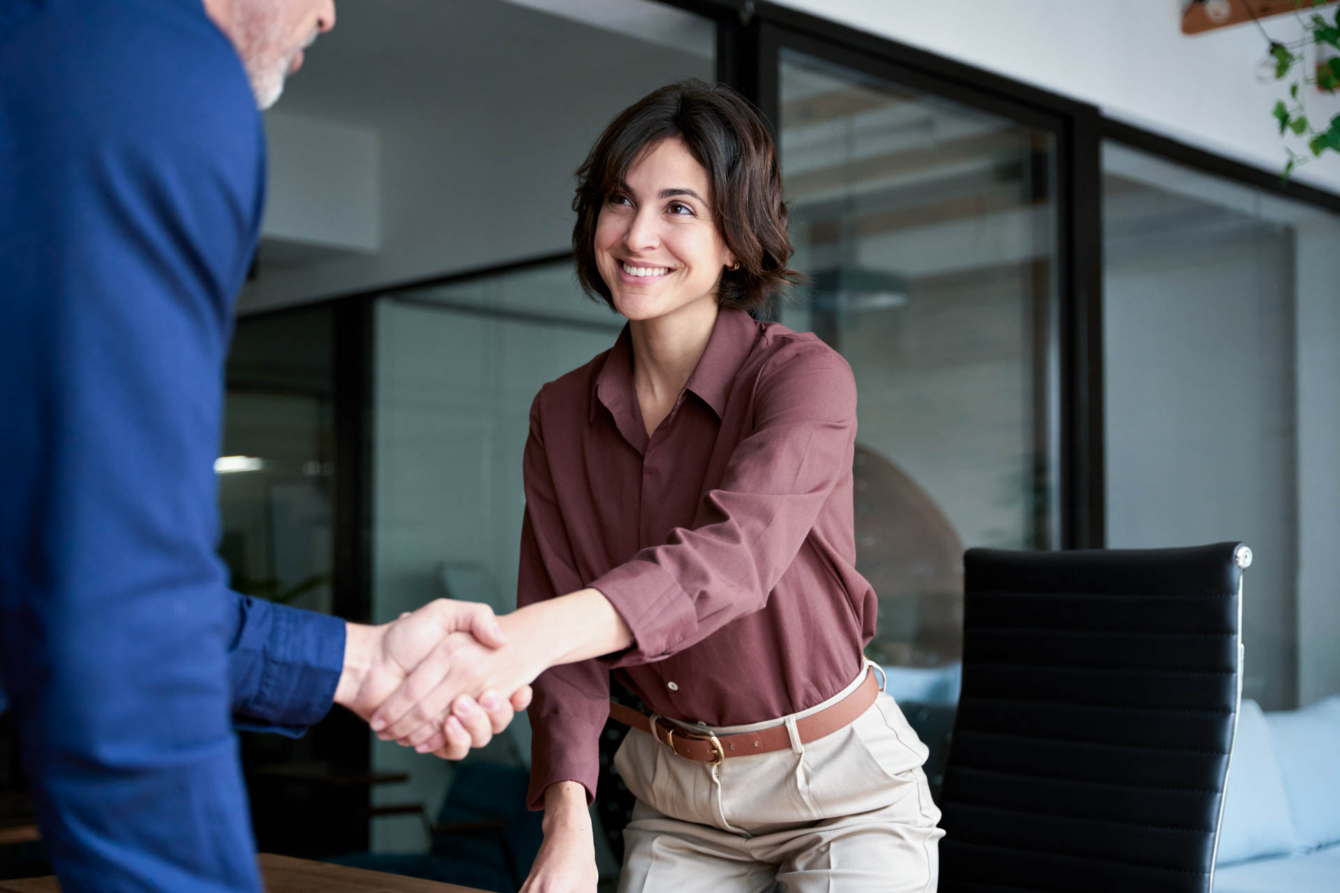 a women and a man shaking hands in an office