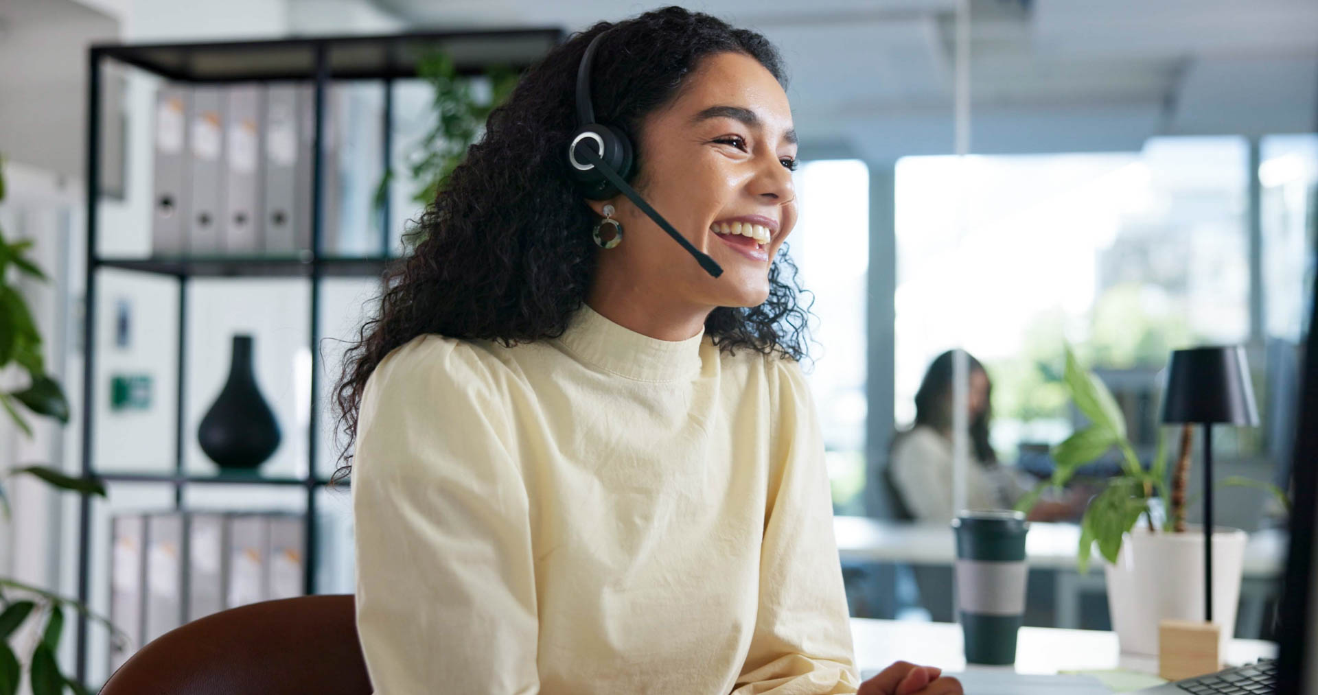 woman smiling while having a call in an office