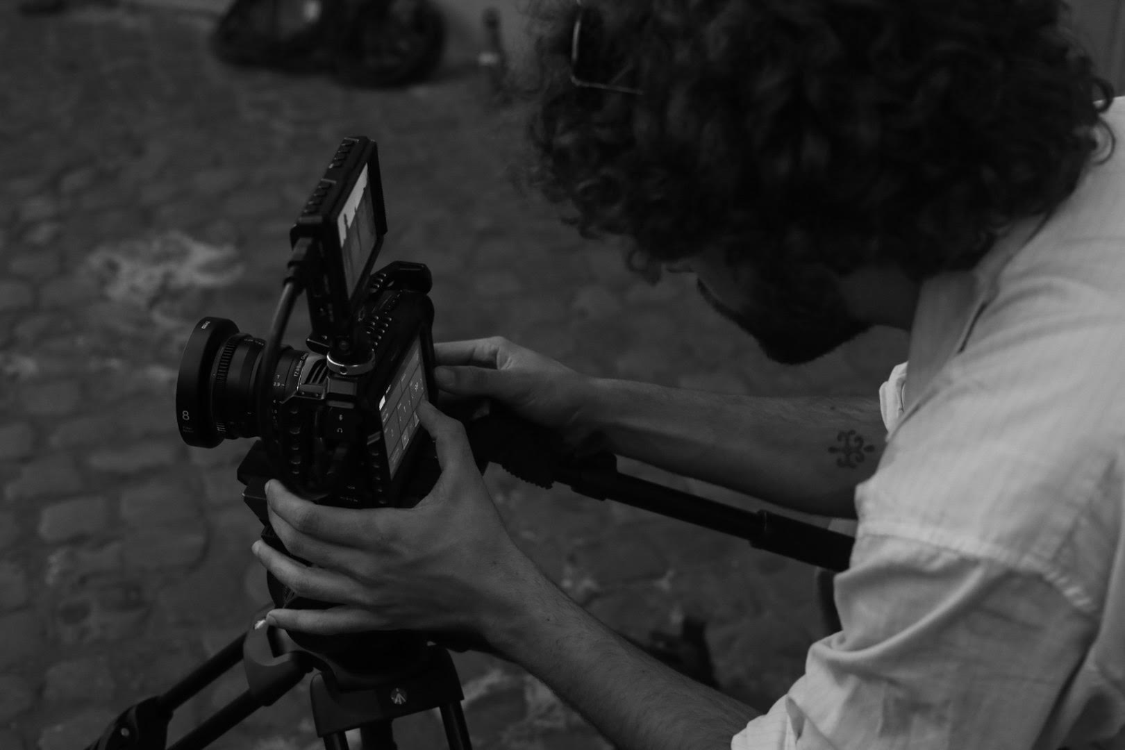 student on set holding camera