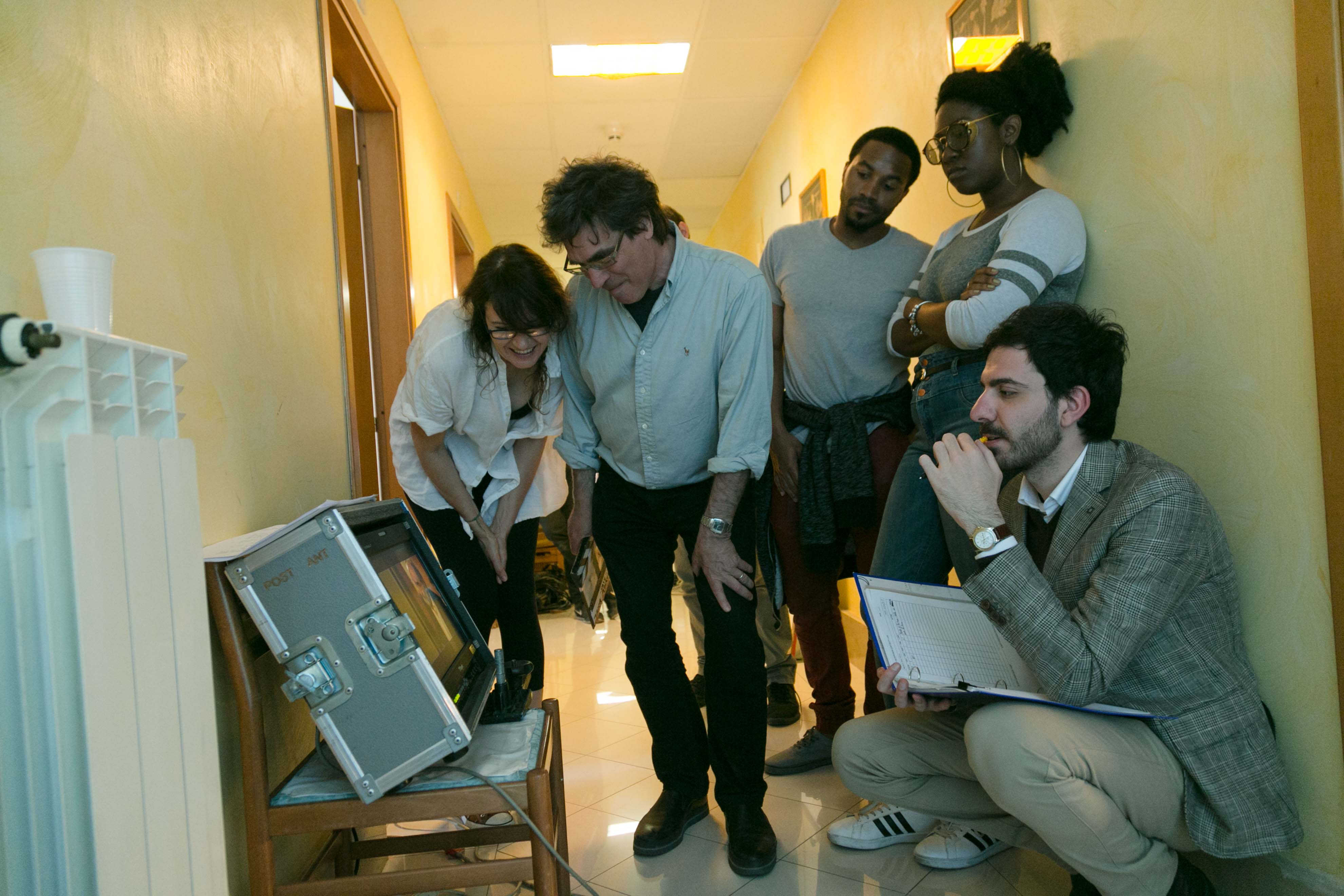 Teacher and students gathered round a monitor 