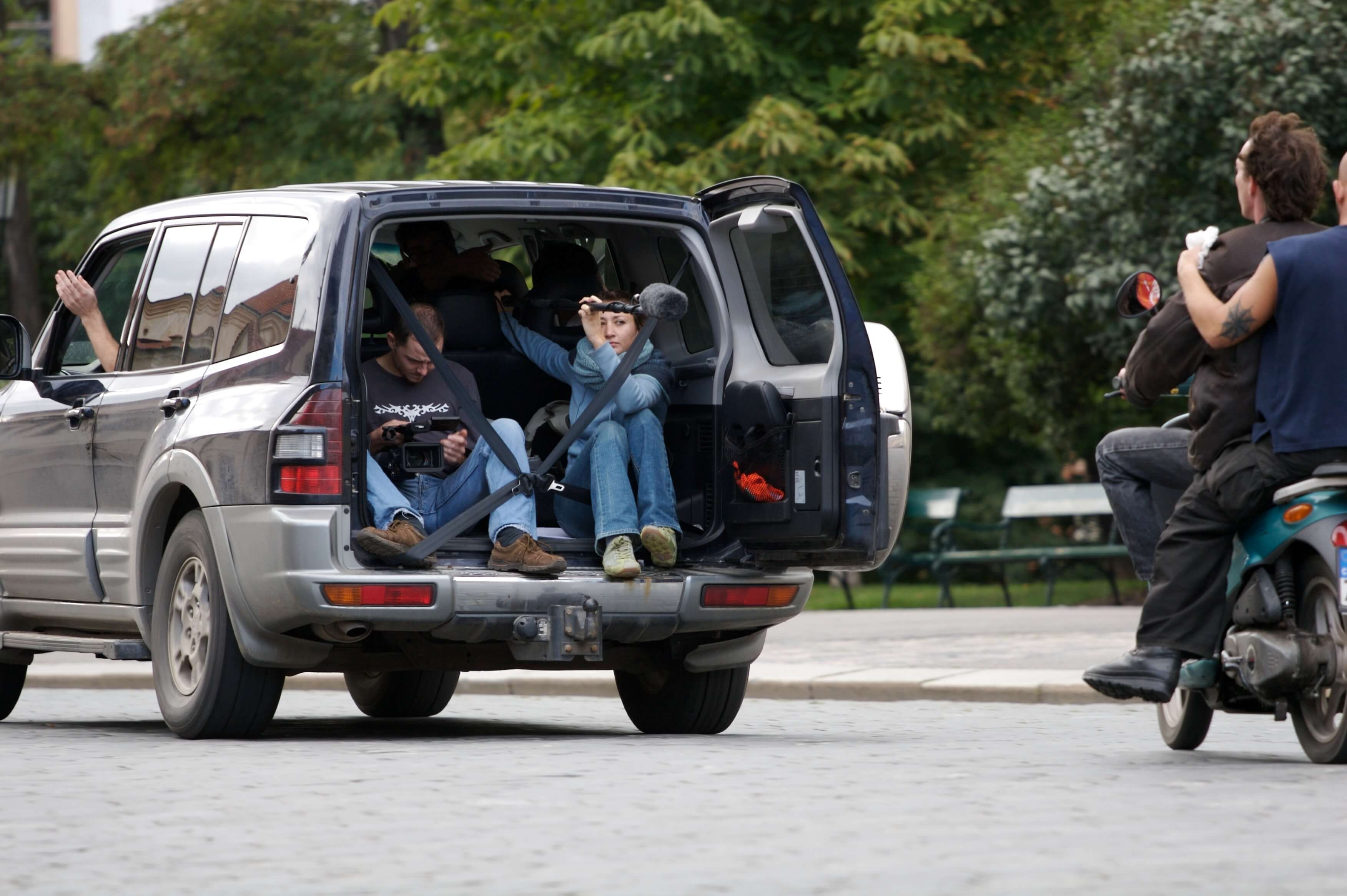 Students in the back of a car on set 