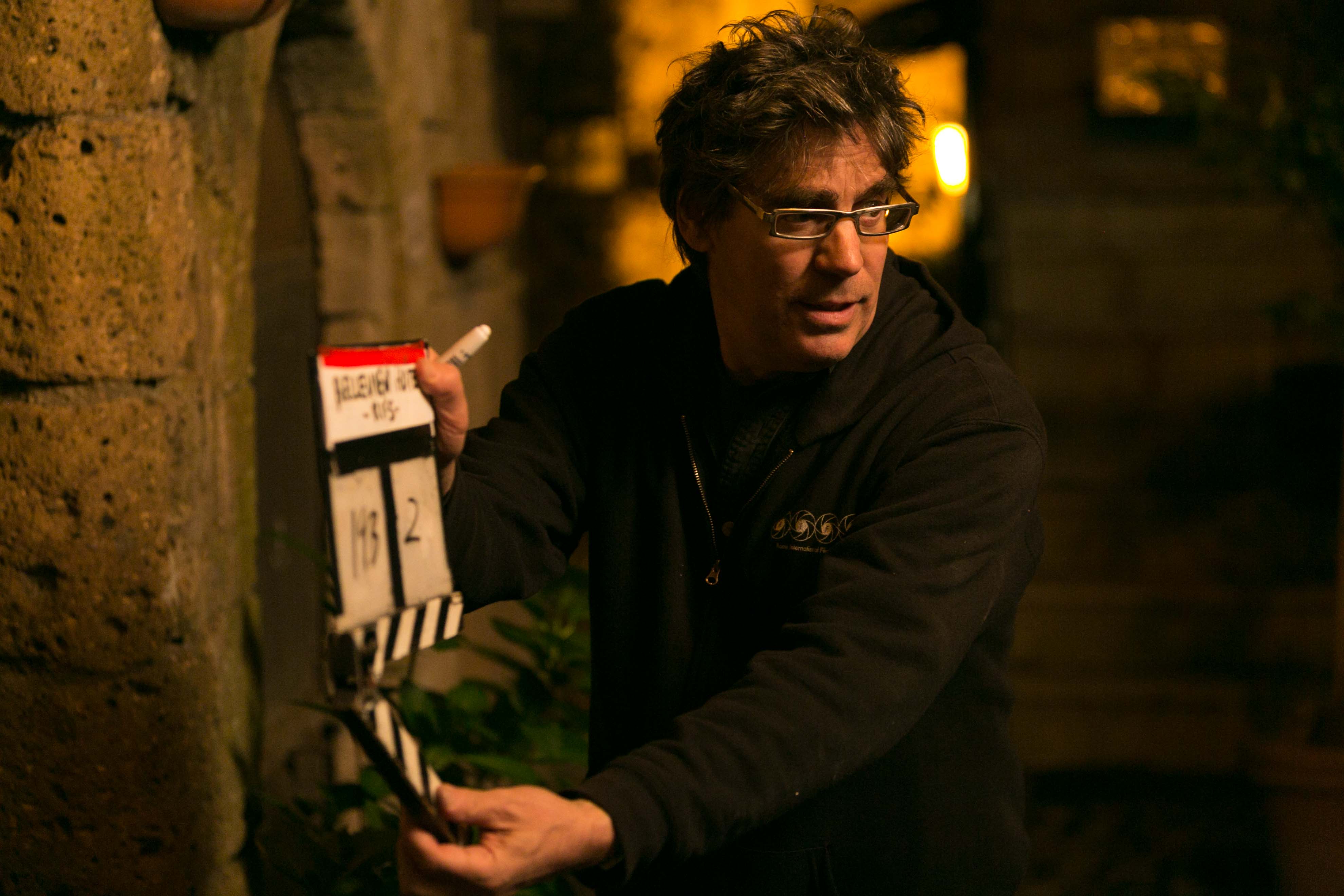 Teacher on set with a clapper board 