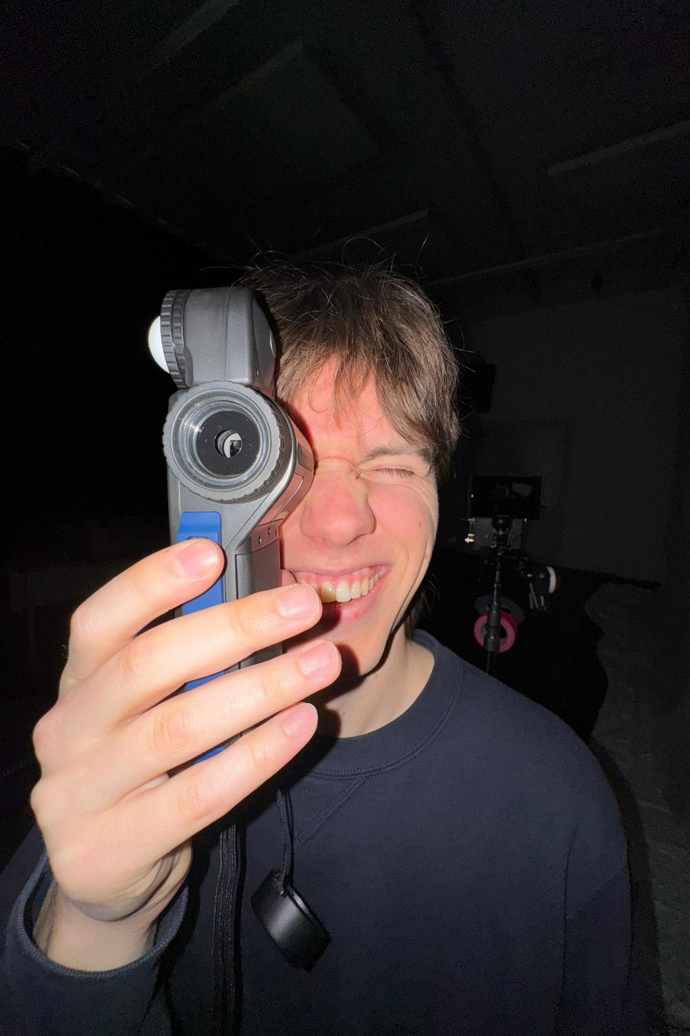 me holding a lightmeter in a funny wide angle picture