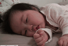 A sweet, sleepy baby drowsily drifts off to sleep.