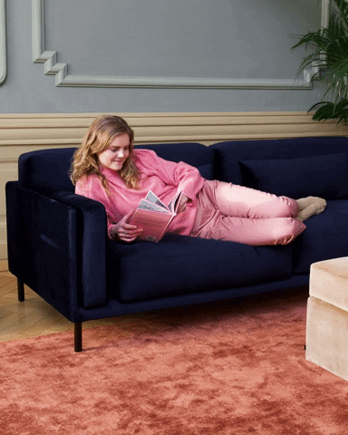 Girl reading a book in the couch