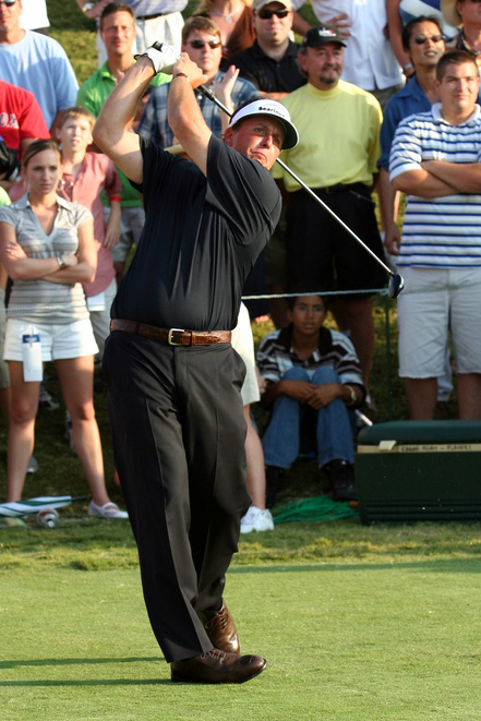 Phil Mickelson holding his driver in the follow through of a swing