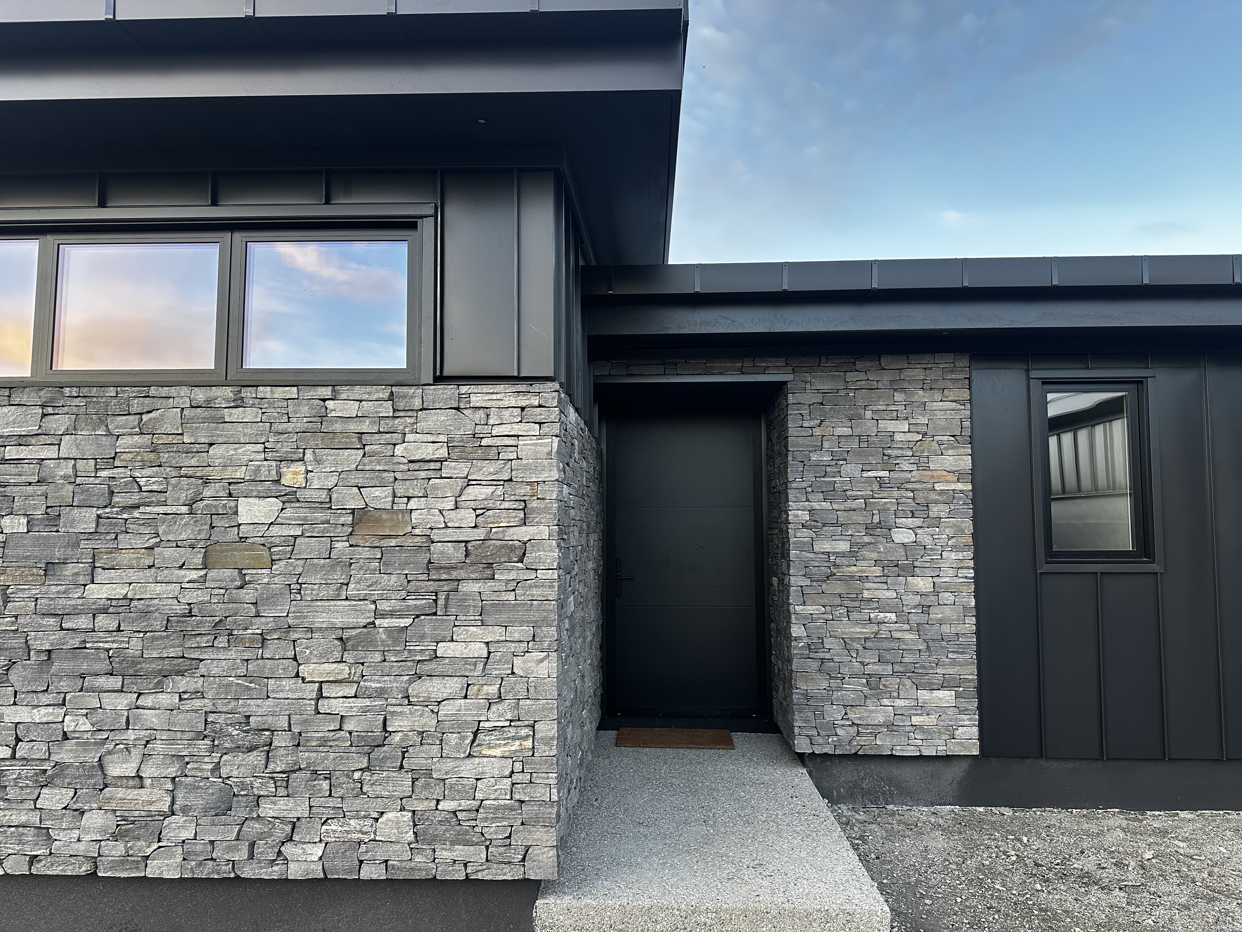 Finished front entry with exposed aggregate path