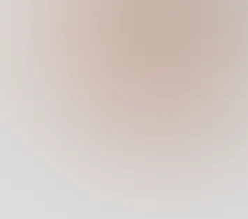 Blurry gradient background with soft beige, pink, and gray tones.