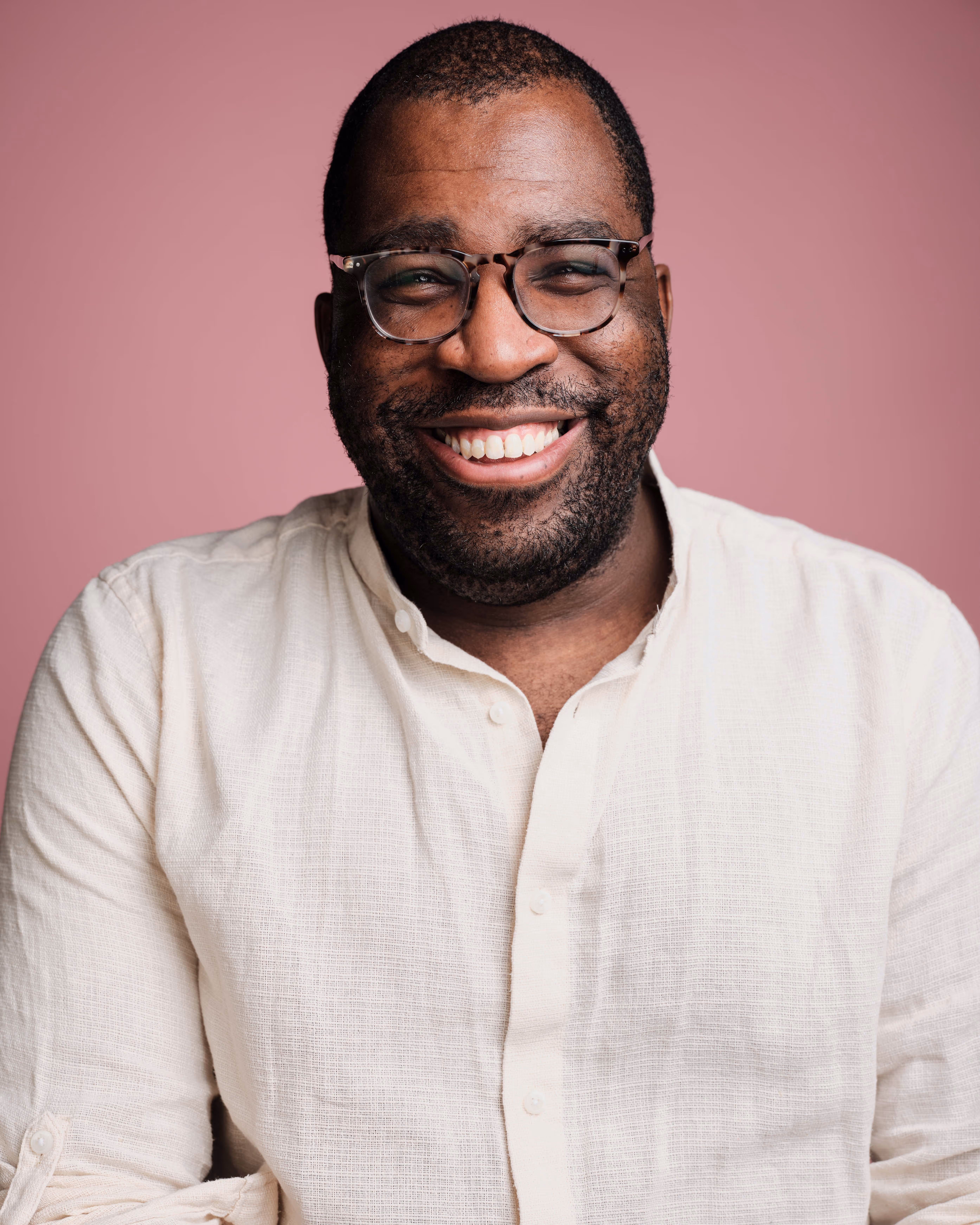 Tray Epps, a beautiful black man smiles at the camera