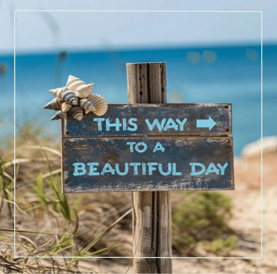 Wooden sign with shells at the beach reads ‘This way to a beautiful day’