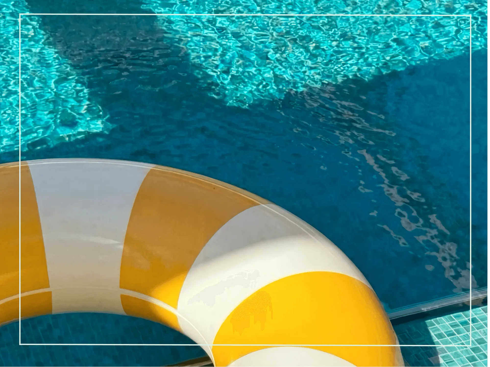 Yellow and white pool float in a boutique hotel swimming pool with sparkling blue water
