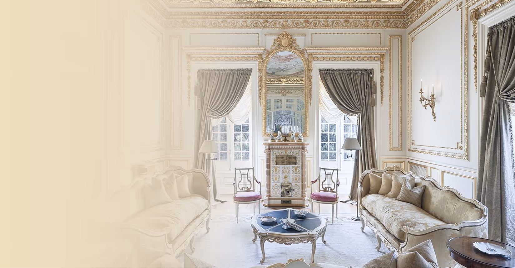 “Elegant drawing room with gilded plasterwork, tall sash windows, silk drapes, and antique sofas around a decorative fireplace.”