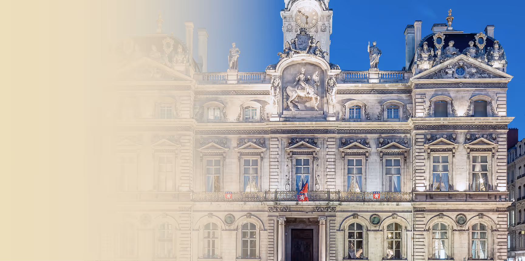 “Illuminated baroque-style façade of a grand historic building at night, with statues, clocktower, and ornate stone carvings.”